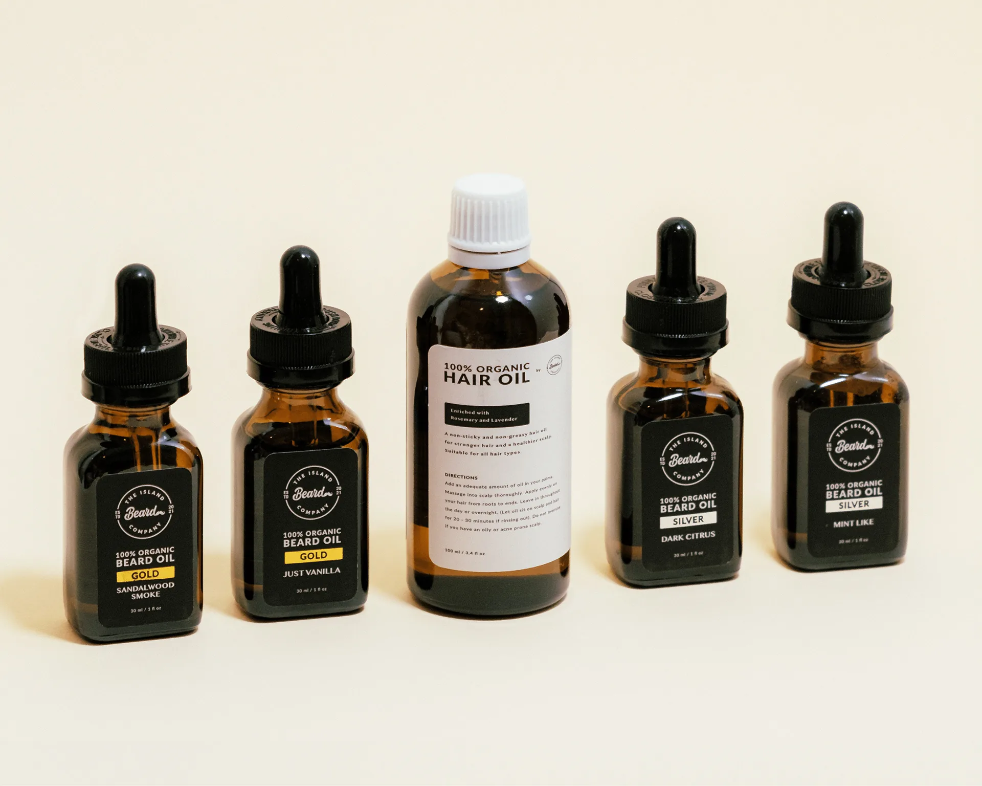 Island Beard product range: four beard oil bottles and a hair oil bottle