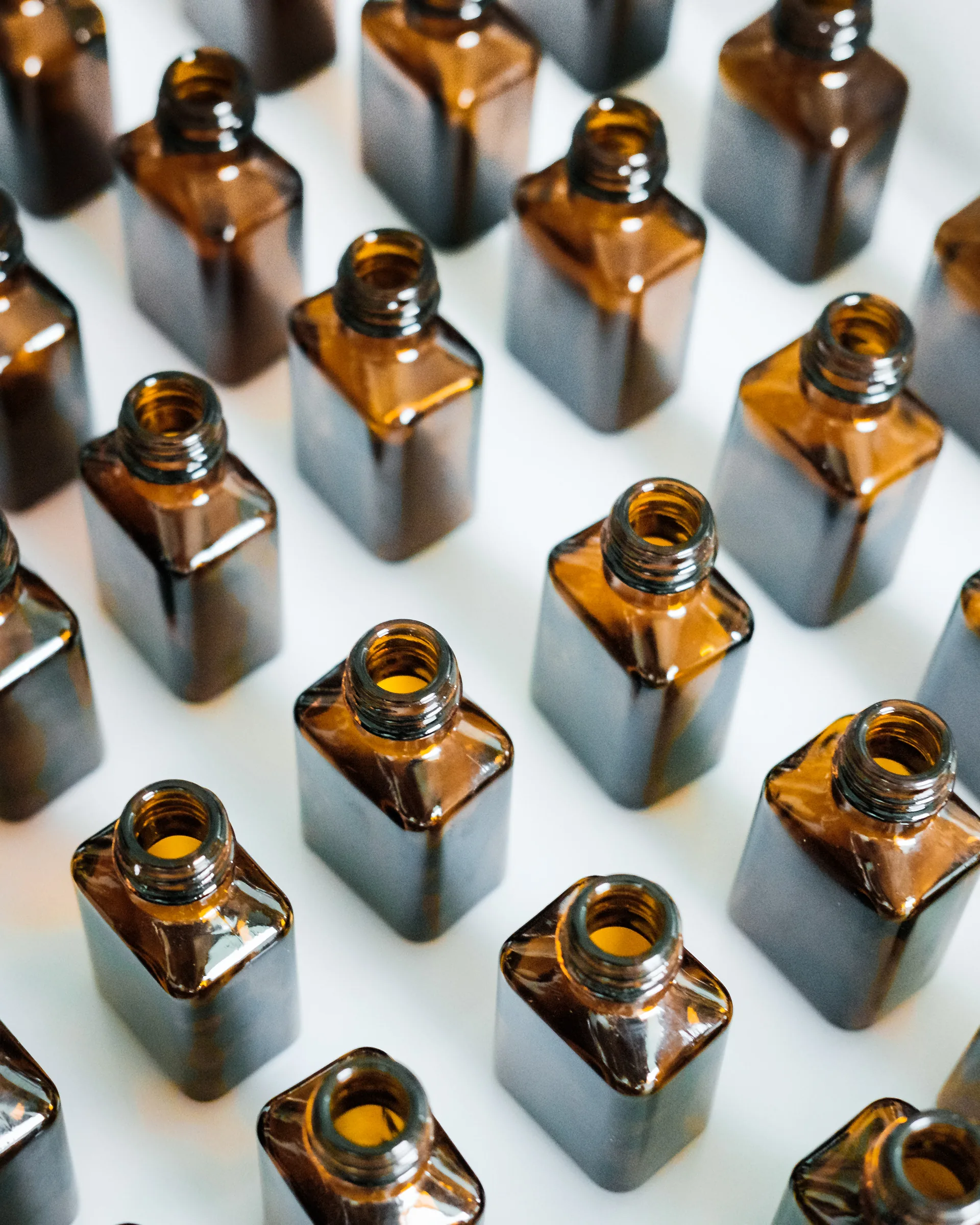 Amber bottles arranged in rows, seen from above